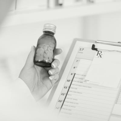 Close up of pharmacist holding bottle of medication