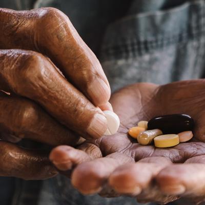 Photo of hands holding pills