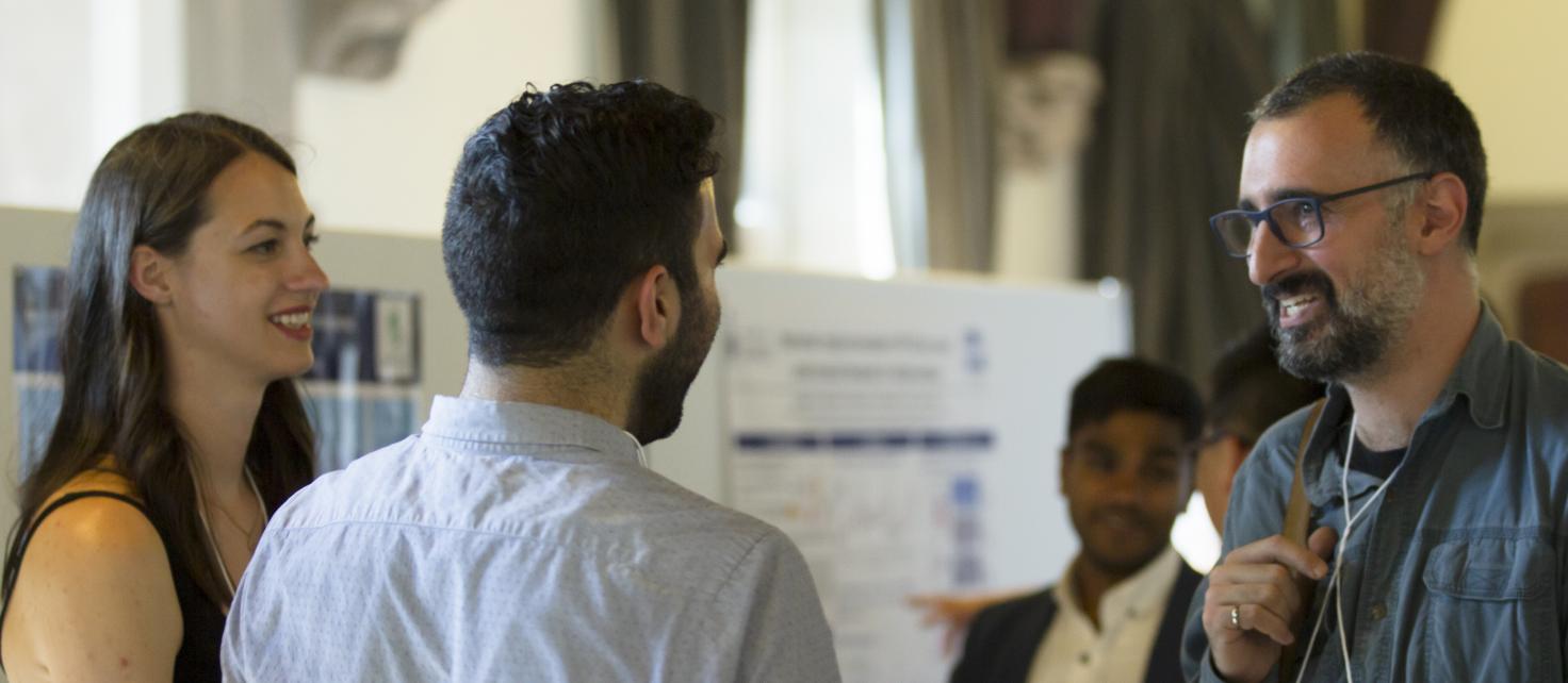 Graduate Students conversing with Dr. David Dubins