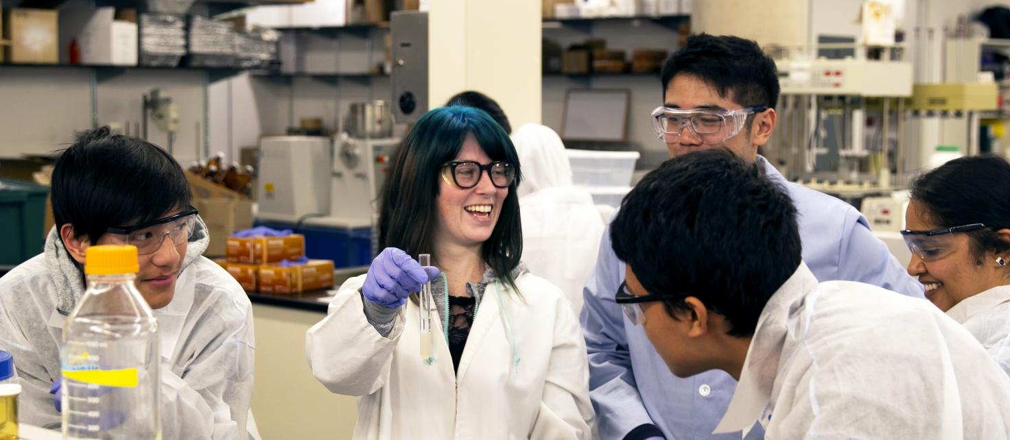Graduate Student with Undergraduate Students in lab