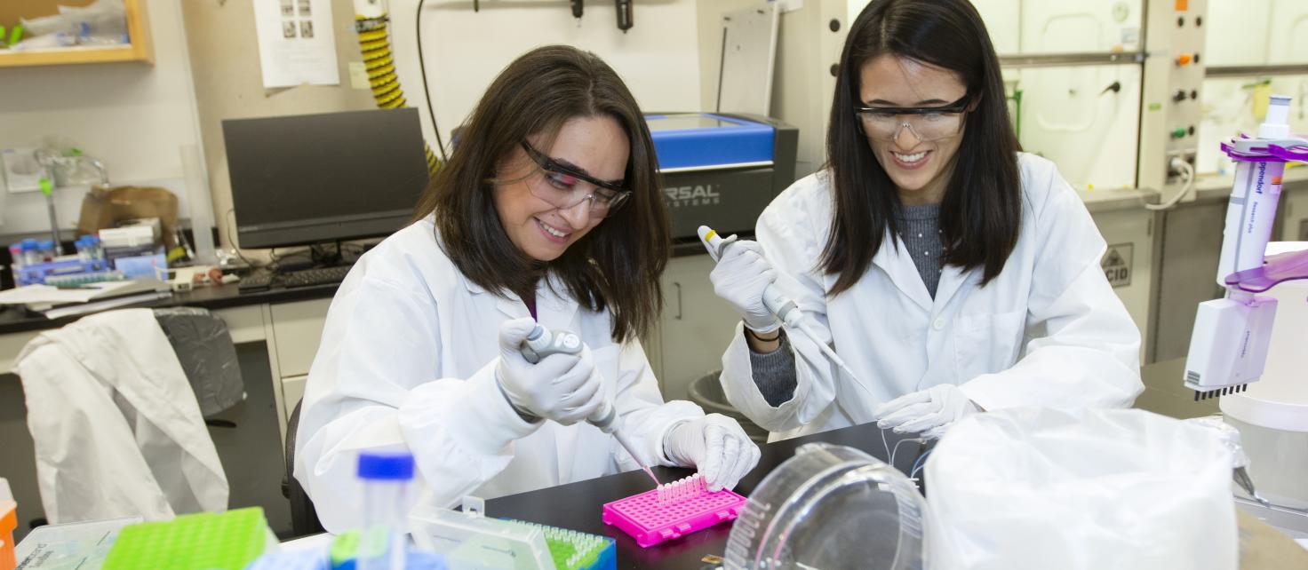 Two female graduate trainees working in the lab