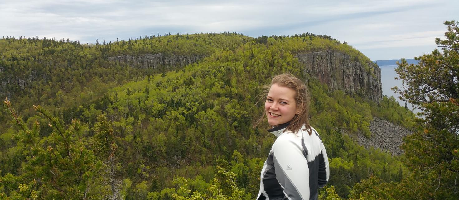 Emma Koivu pictured outside in front of forest landscape in Thunder Bay