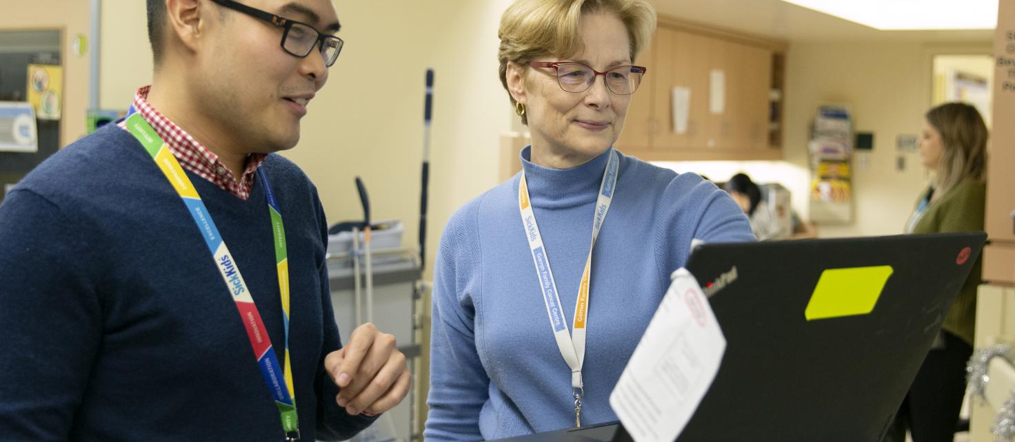 Two pharmacists talking in hallway