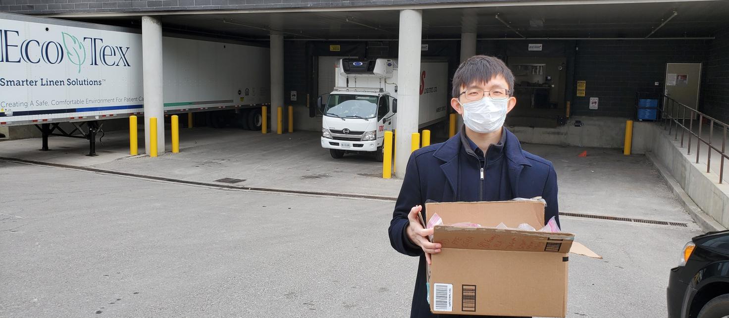 Peter Zhang holding PPE