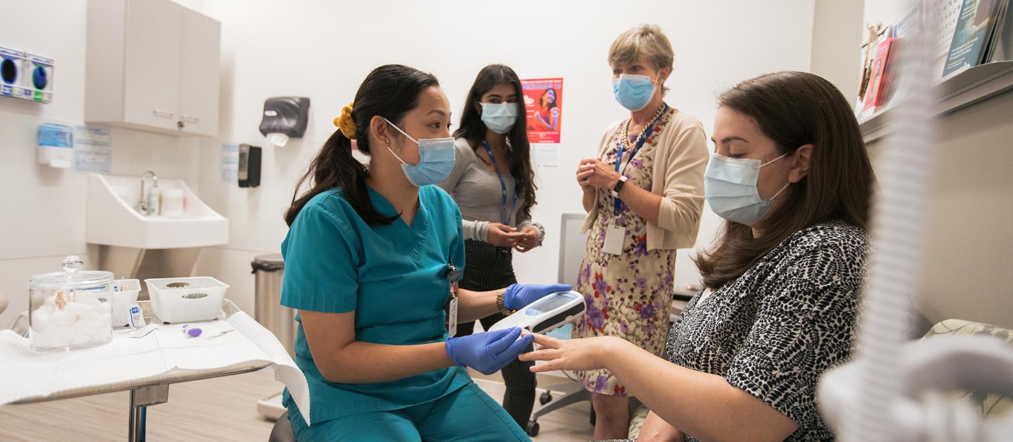 Photo of preceptor Heather Hadden, PharmD student Sonia Gupta working at Carepoint Health