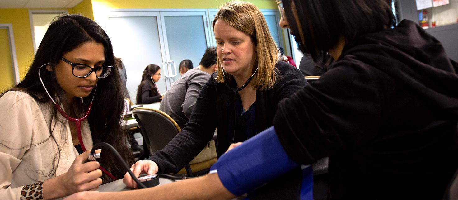 Natalie Crown works with PharmD students during a second year pharmacy course