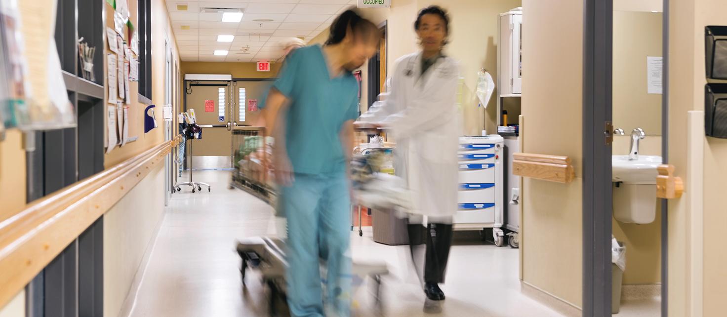 Blurred photo of hospital staff walking with stretcher