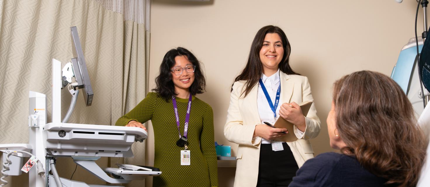 Two pharmacists consulting a patient in a hospital dialysis unit