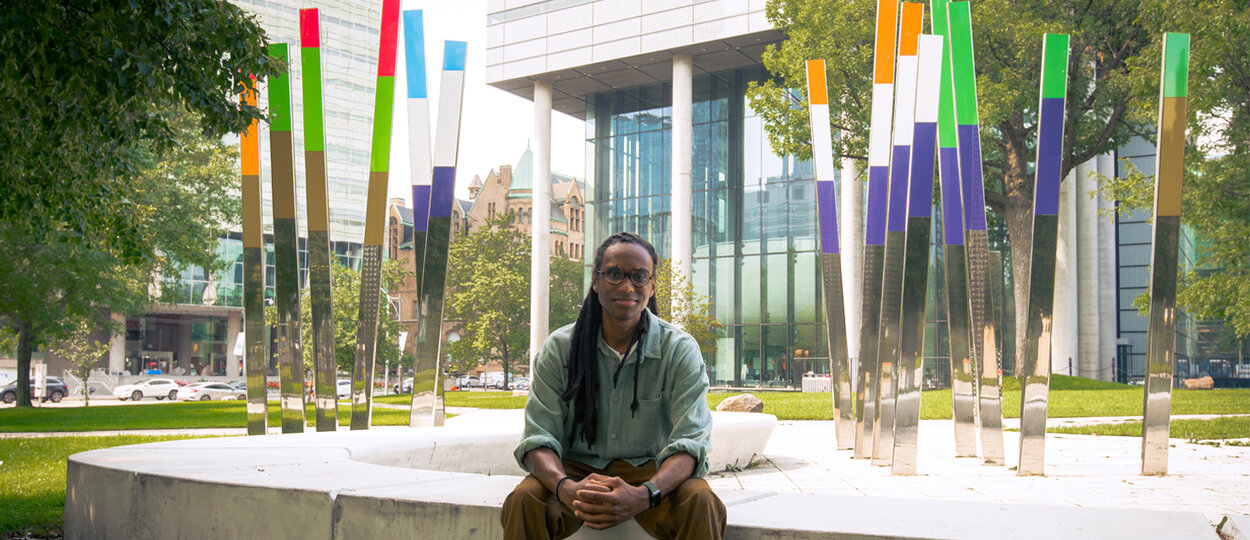 PharmSci MSc graduate Julian Gilmore photographed outside the Leslie Dan Faculty of Pharmacy building