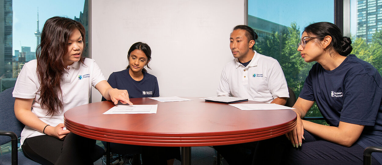 Members of the Discovery Pharmacy team sitting around table