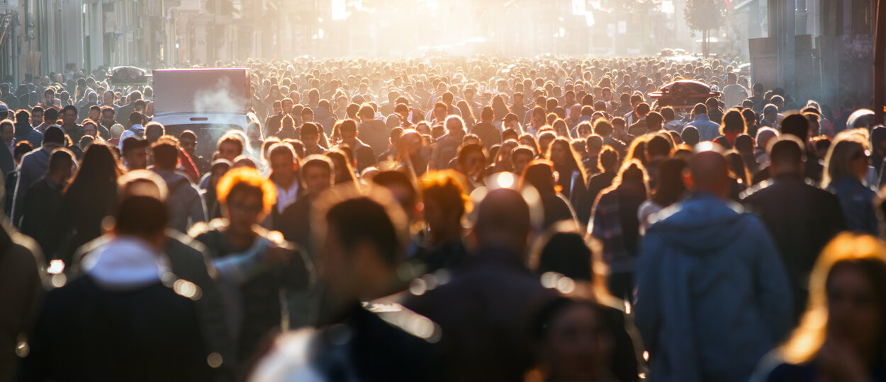 Crowd walking down busy street