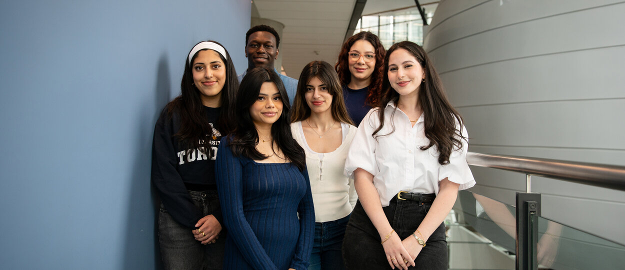 Group of six students with pharmacy pod in background