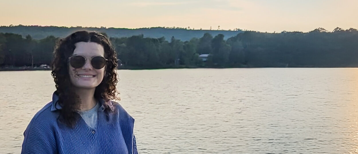 Portrait of PharmD student Alina Montgomery with lake in the background at sunset