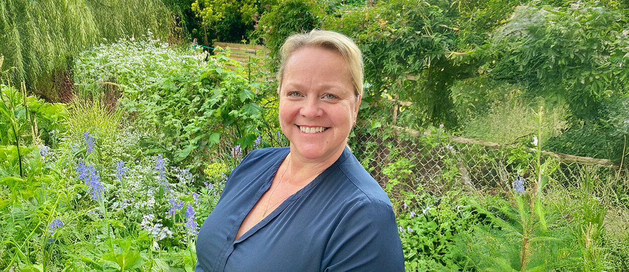 Brandi Cambray photographed infront of green garden