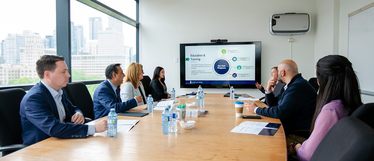 MPP Deepak Anand and MPP Natalie Pierre meeting with University of Toronto faculty and staff in a boardroom