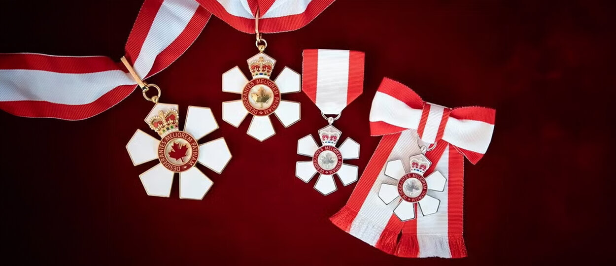 Medals for the various levels of the Order of Canada displayed on a table