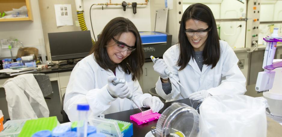 Two female graduate trainees working in the lab