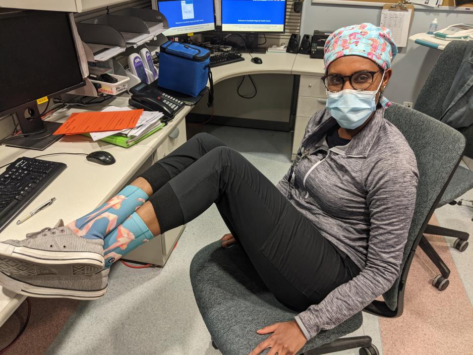 Hospital pharmacist Erita Habtom showing off matching socks at work