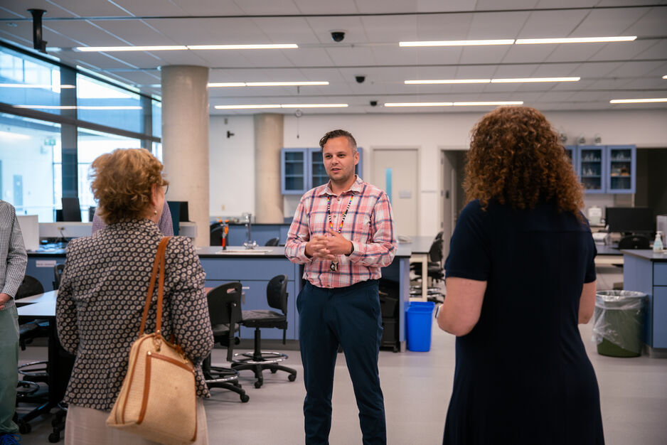 Pharmacist and Indigenous Engagement Lead Jaris Swidrovich speaks about pharmacy practice training in the Leslie Dan Faculty of Pharmacy's professional practice lab during a tour with MPP Robin Martin.