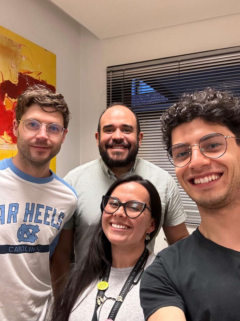 Four researchers smiling at camera in office space