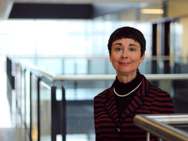 Image of woman standing in open office space