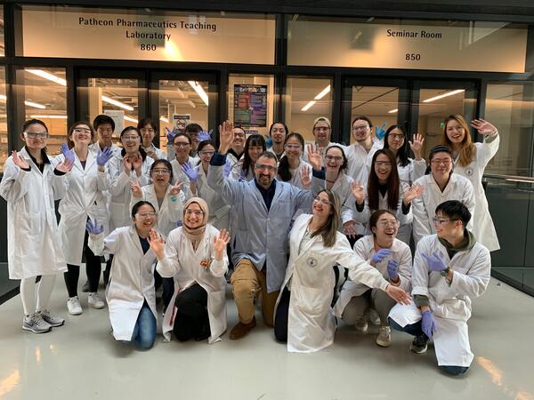 Professor David Dubins and students outside of lab