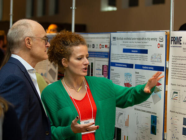 Graduate Student Presenting Research Poster