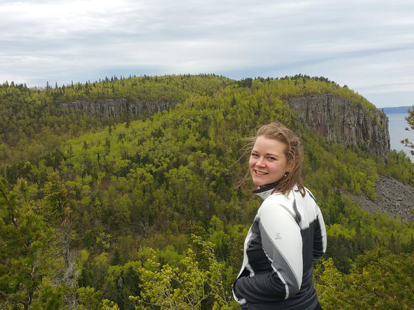 Emma Koivu pictured outside in front of forest landscape in Thunder Bay