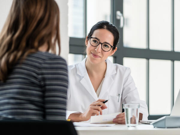 Female pharmacist talking with patient