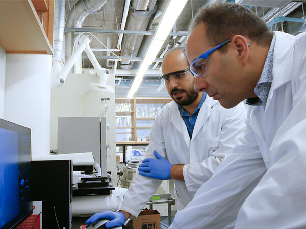 Professor Stephane Angers & Post-doc Rony Chidiac working in lab