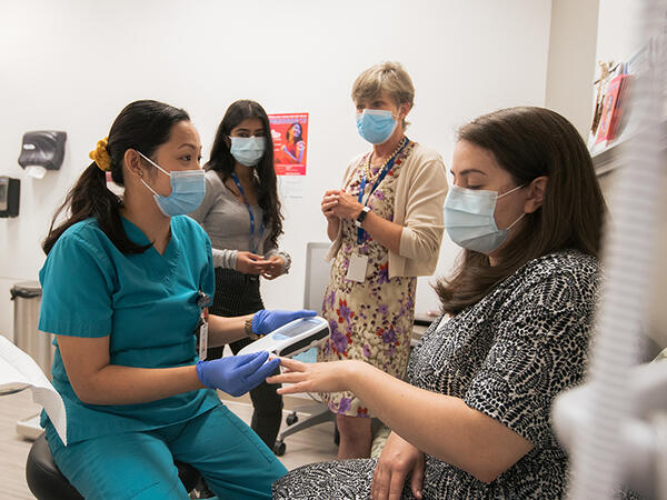 Photo of preceptor Heather Hadden, PharmD student Sonia Gupta working at Carepoint Health