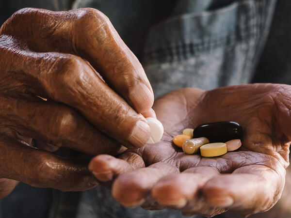 Photo of hands holding pills