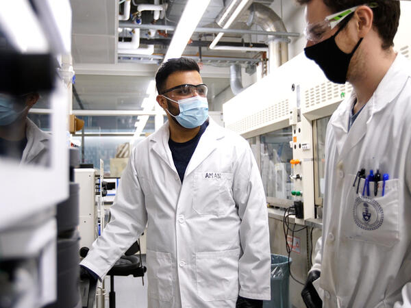 Portrait of Comp Sci student Aman Sisodia with PharmSci PhD student Jack Bufton in lab