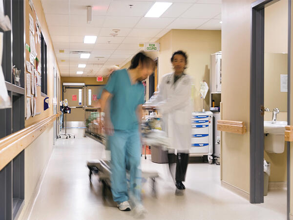Blurred photo of hospital staff walking with stretcher