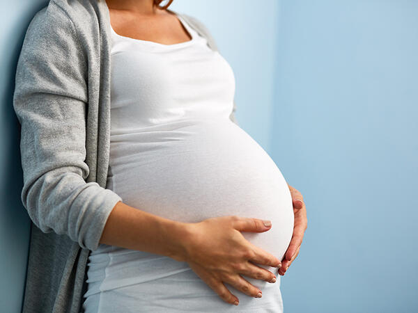 Pregnant person holding baby bump
