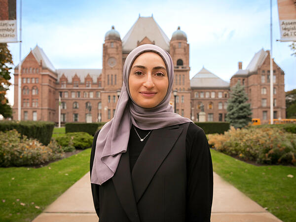 Portrait of Fourth Year PharmD Student Tahani Dakak standing in front of Queen's Park