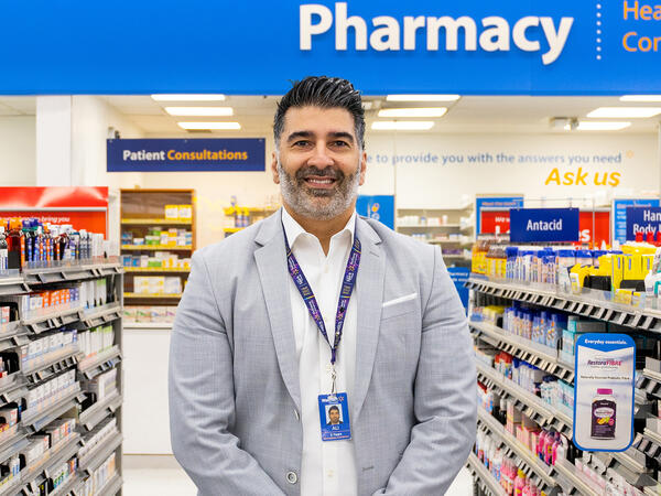 Photo of Ali Ahmadian standing in a Walmart Pharmacy