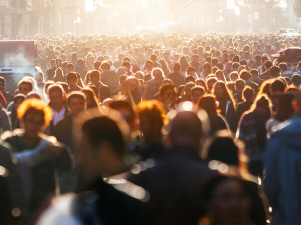 Crowd walking down busy street