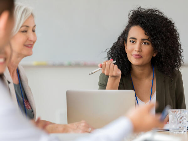 Mid adult woman listens to doctors