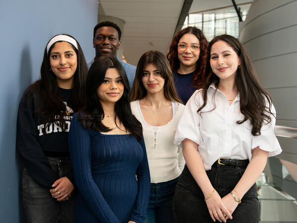 Group of six students with pharmacy pod in background Group of six students with pharmacy pod in background