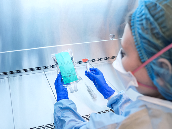 Scientist working under lab hood Scientist working under lab hood