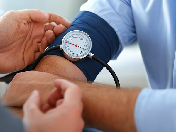 Physical Assessment Feature Hands taking blood pressure with focus on blood pressure metre
