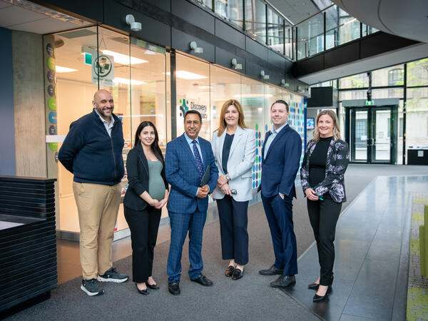 MPP Deepak Anand and MPP Natalie Pierre pictured with U of T Faculty and Staff
