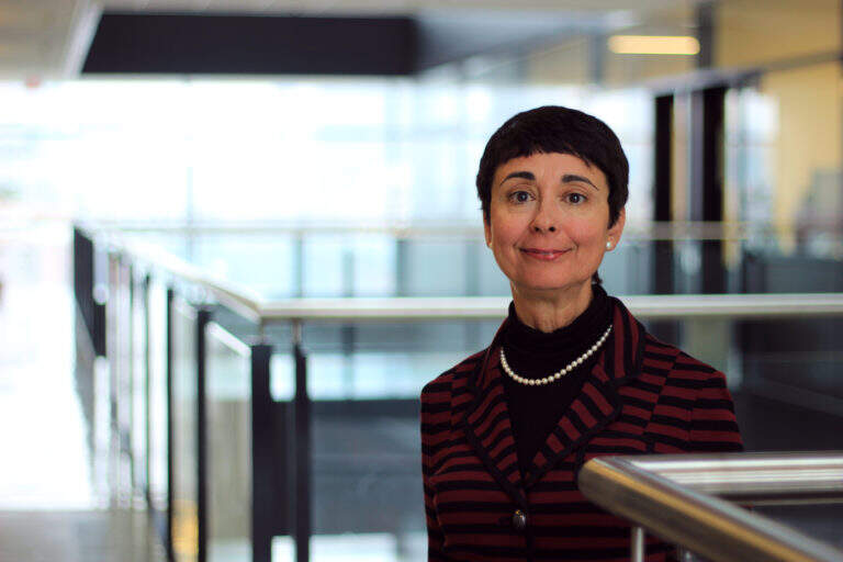 Reina-Bendaya Image of woman standing in open office space