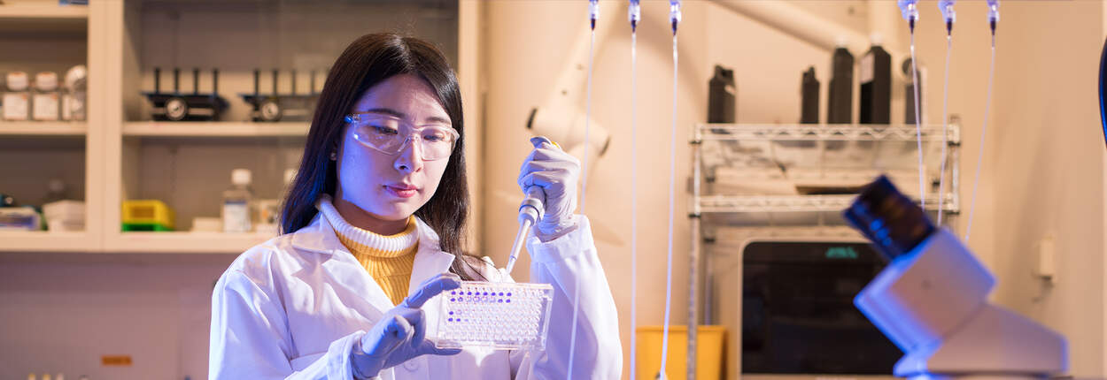 PharmSci Graduate Student Gloria in lab