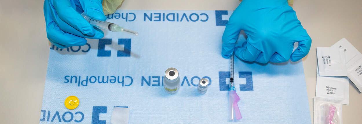 Close-up shot of hands handling COVID-19 vaccine Close-up shot of hands handling COVID-19 vaccine