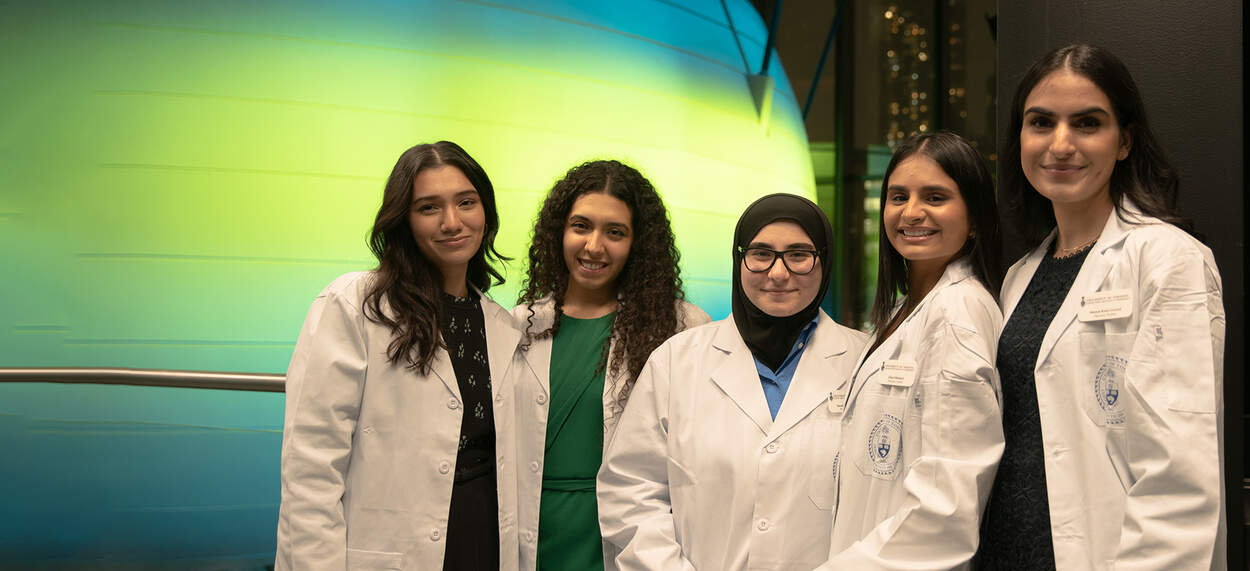 Pharmacy Students standing in front of lecture pod at Leslie Dan Faculty of Pharmacy