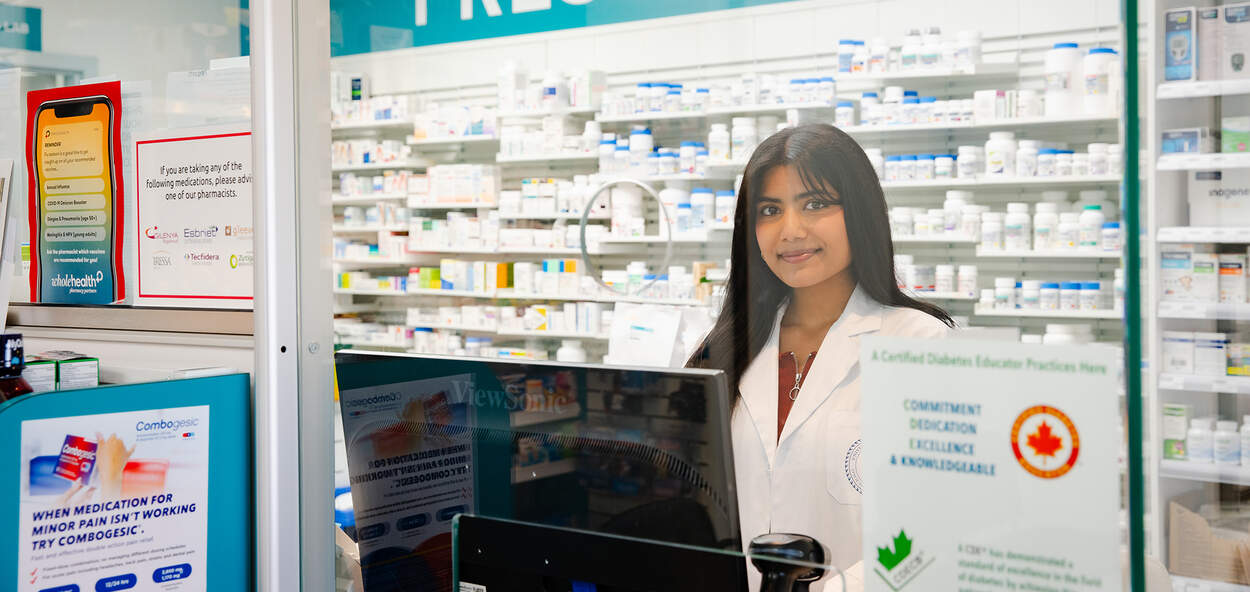 PharmD student on rotation, behind a pharmacy counter