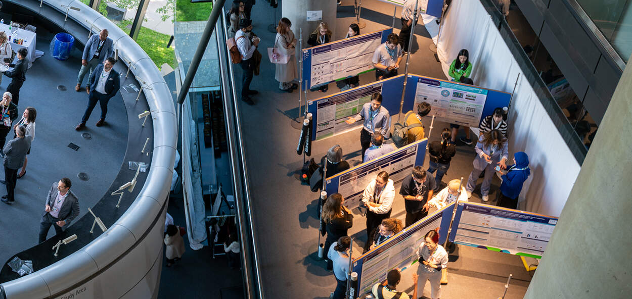 Overhead view of graduate students presenting research at the Leslie Dan Faculty of Pharmacy