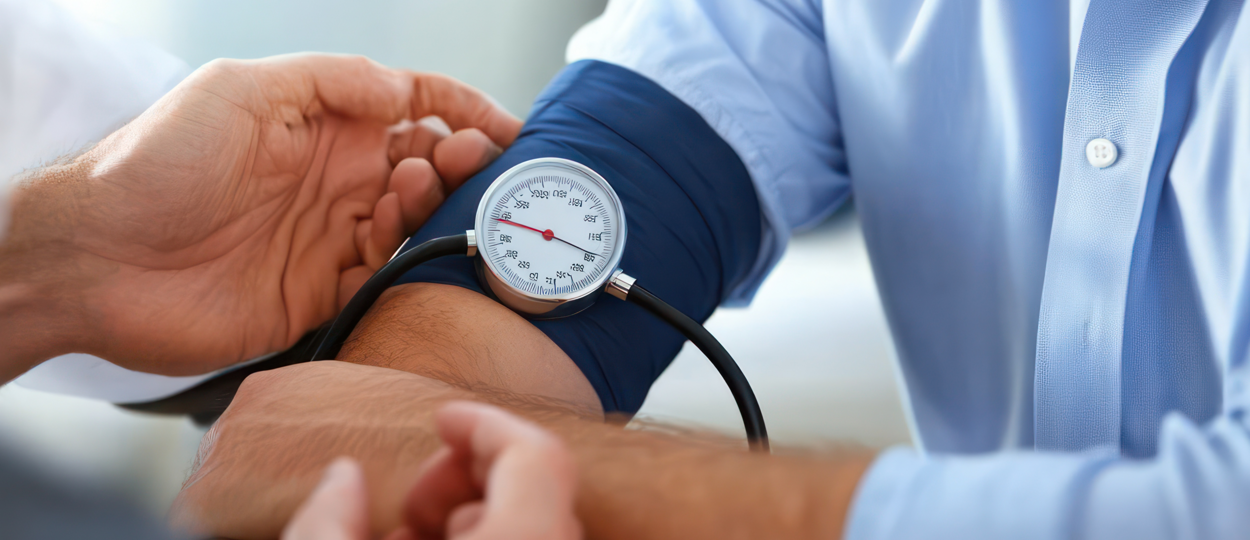 Physical Assessment Hands taking blood pressure with focus on blood pressure metre